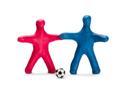 Plasticine small people soccer players with ball isolated on whiteの写真素材