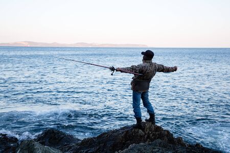 Fisherman admires the open spaces in the early morningの写真素材