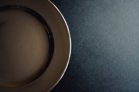 Top view of empty plate on the black table