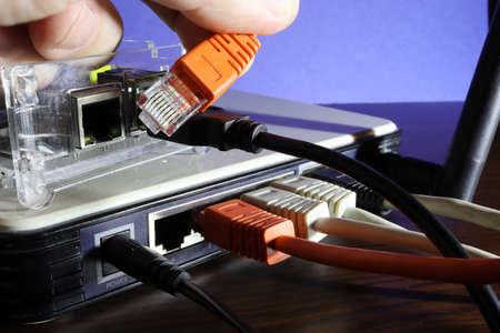 Detail of the UTP connector of the communication cable when connected to a mini PC. Wifi switch.の写真素材