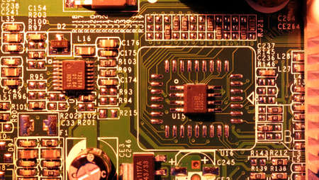 Soft focus. Concept of micro chips in red backlight. Detail of microchips on an electronic circuit...