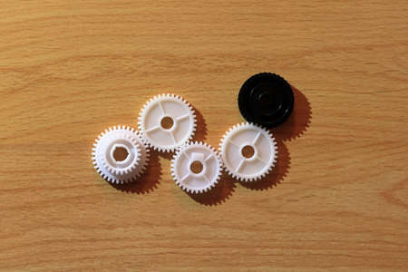 Gears assembled into a single mechanism. Wooden background.の写真素材
