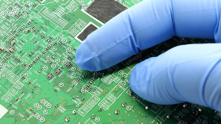 A close-up view of the printed circuit board. Electrical engineer holding a circuit board with microchips in his hand.  Standard marking of electronic components.の写真素材