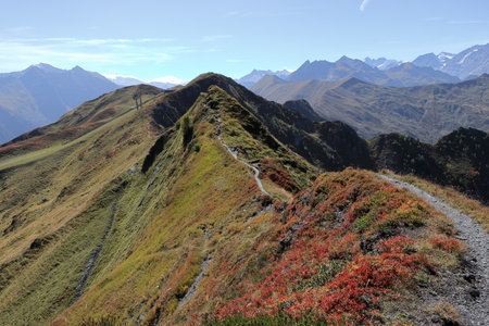 Mountain path leading along the mountain ridge. Blue sky, sunny day. View of the mountains near Rauris in Austriaの写真素材