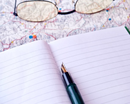 notebook on a map, plannign your holidays??の写真素材