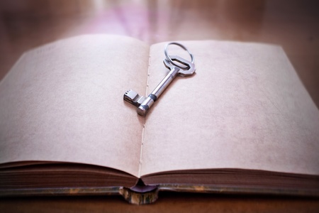 Old key on a open book