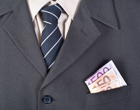 Close up photo of money in the businessman pocketの写真素材