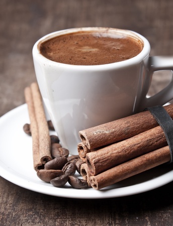 cup of coffee and cinnamon on old plankの写真素材