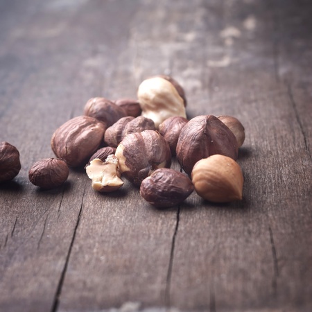 Close up photo of hazelnut on wooden plankの写真素材