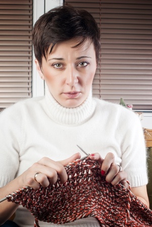 Woman Sitting In Chair Knittingの写真素材
