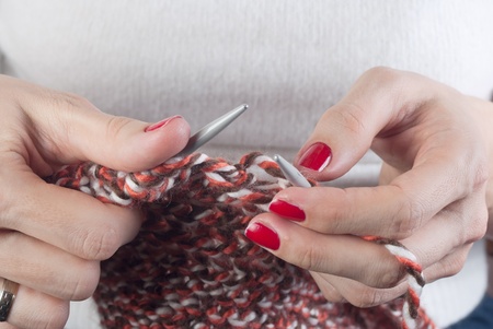 Hands of a young woman knitting