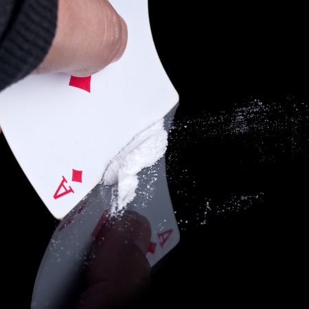 cocaine or other drugs cut with playing card on mirror. の写真素材