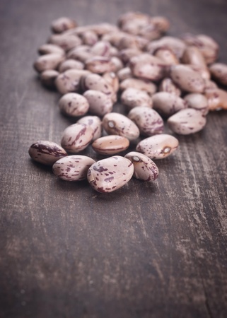 close up photo of different kinds of beans on old plankの写真素材