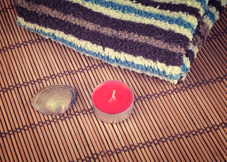 towel, candle and shell on bamboo backgroundの写真素材