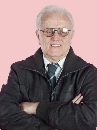 Senior businessman portrait with arms crossed, smiling at camera.の写真素材