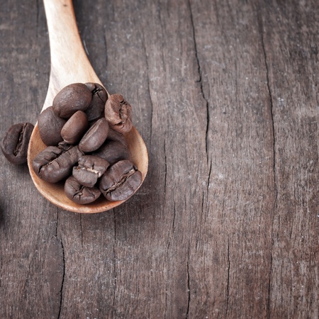 coffee beans in wooden spoonの写真素材