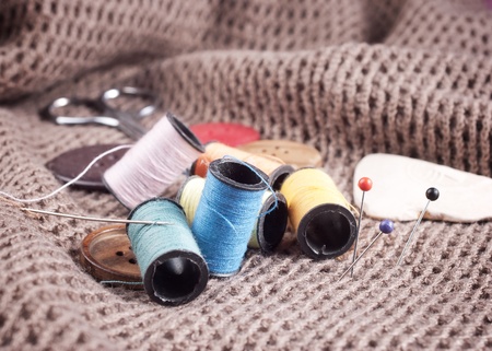 Many bobbin of thread with needle and buttonの写真素材