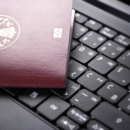close up photo of  passport on the keyboardの写真素材