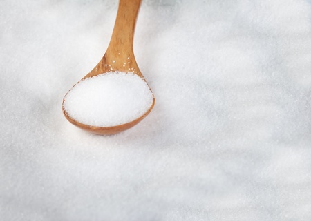 salt in a brown wooden spoonの写真素材