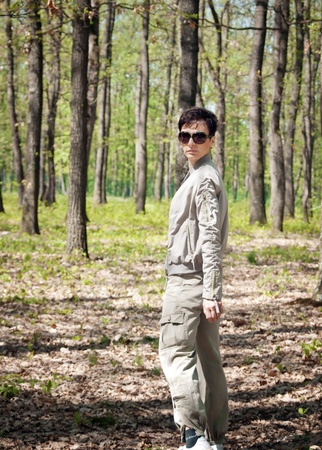 beautiful woman in the spring walk through the forestの写真素材