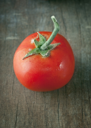fresh tomato on old wooden tableの写真素材