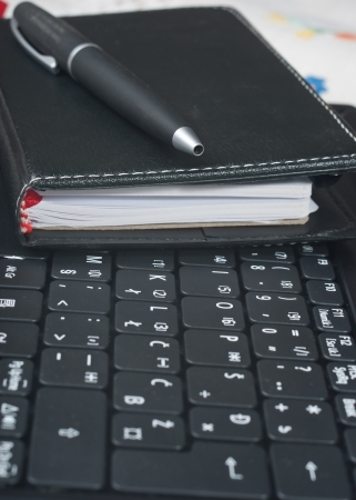 Business items on laptop computerの写真素材