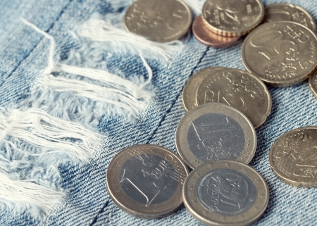 euro coins on blue jeans backgroundの写真素材