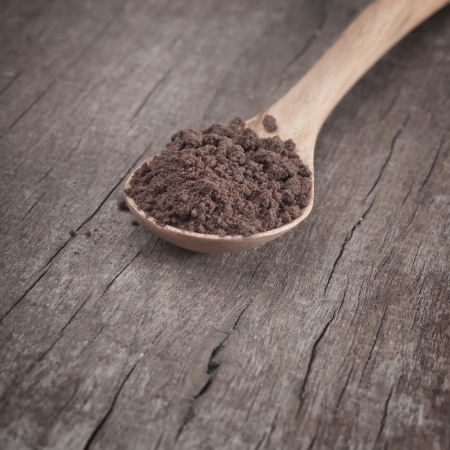 Instant coffee in the spoon on wooden tableの写真素材