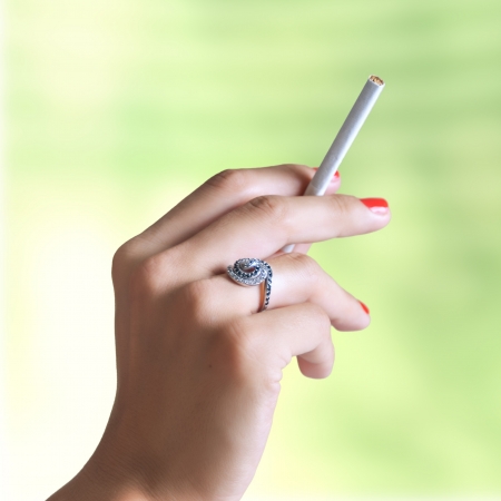 close up of female hand with cigaretteの写真素材