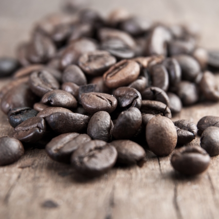 close up of coffee beans on old wooden ableの写真素材