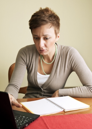 close up of woman on her laptop at homeの写真素材