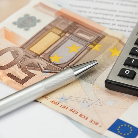 calculator and pen, with  euro banknoteの写真素材