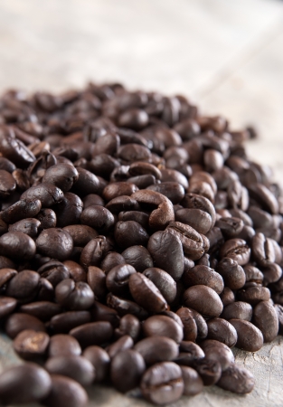 close up of coffee beans on old wooden tableの写真素材
