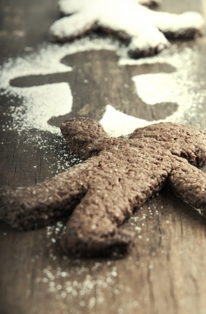 Christmas biscuits with icing sugar on wooden table