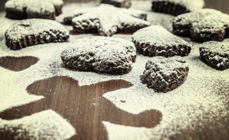 Christmas biscuits with icing sugar on wooden tableの写真素材
