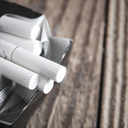 Close-up of cigarettes in pack on table