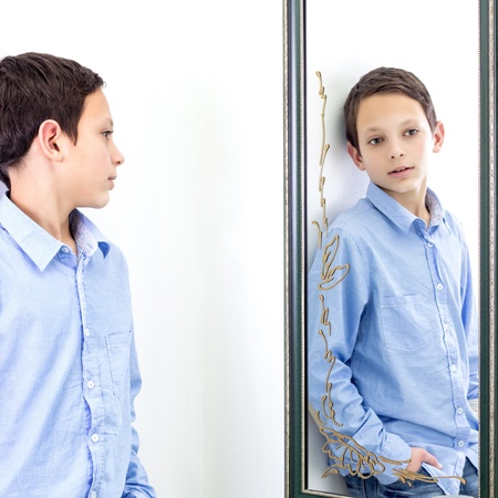 boy posing in front of mirrorの写真素材
