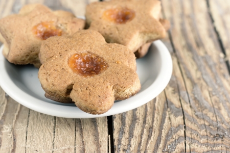 Almond cookies with fruit jam on tableの写真素材