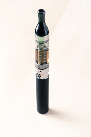 Black electronic nicotine inhalator on table,e-cigaretteの写真素材