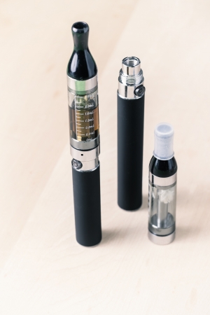 Black electronic nicotine inhalator on table,e-cigaretteの写真素材