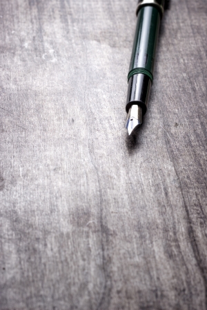 Fountain pen on old wooden backgroundの写真素材