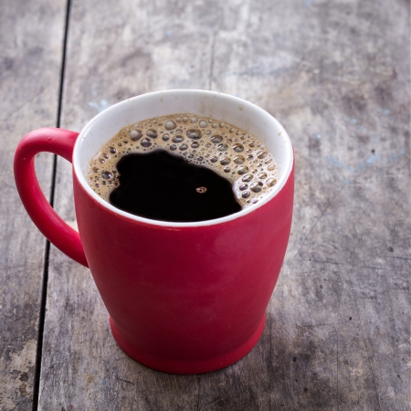 old red coffee mug on table, close upの写真素材
