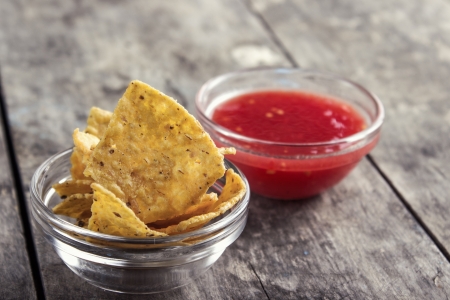 Bowl of Salsa and tortilla chips on the  wooden tableの写真素材