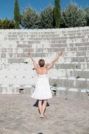 outdoor portrait of woman lifted hands to skyの写真素材