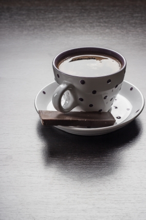 coffee cup and chocolate on wooden tableの写真素材