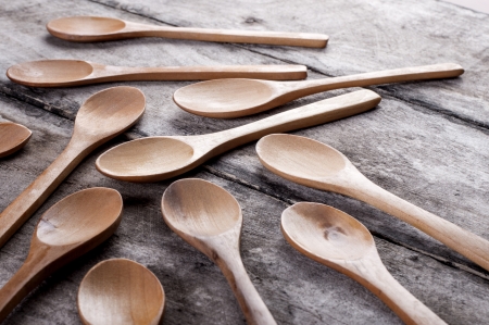 wooden spoons on old wooden background, close upの写真素材