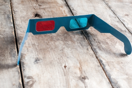 3d glasses on wooden table, close up photoの写真素材