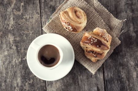 cup of coffee and croissants over wooden backgroundの写真素材