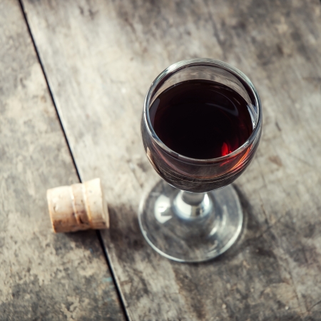 glass  of cherry liqueur on wooden tableの写真素材