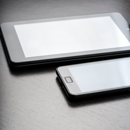 electronic devices on wooden table, close upの写真素材